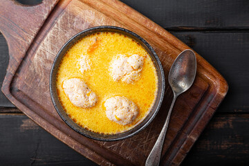 Soup with meatballs, potatoes and cheese on black background top view. Meatballs in thick vegetable soup Albondigas. Mexican and Spanish, European and Russian cuisine