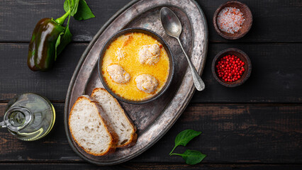 Soup with meatballs, potatoes and cheese on black background. Meatballs in thick vegetable soup Albondigas. Mexican and Spanish, European and Russian cuisine