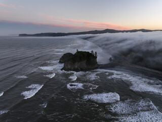 A foggy sunrise along the rocky coast of Washington, USA
