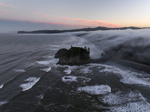 A foggy sunrise along the rocky coast of Washington, USA