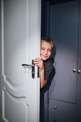 a handsome boy playing hide and seek