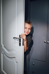 a handsome boy playing hide and seek