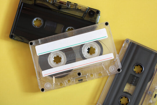 Retro audio cassette tapes on yellow background