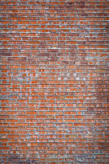 Old red wall from brickwork as background vertical view closeup