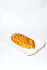 Golden fish-shaped pie on white plate, Perfect for menus, food photography, and advertising