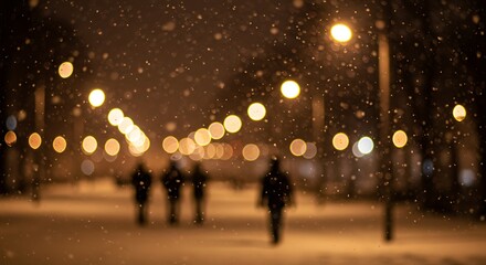 Silhouetted figures walk under streetlights during a snowfall at night