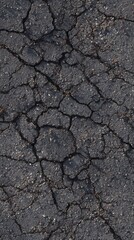 Cracked Asphalt: An evocative close-up view of weathered asphalt, capturing its intricate network of cracks and textures, conveying a sense of age, decay, and the passage of time.