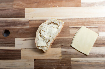 Flat lay composition of bread loaf on wooden board – rustic food scene