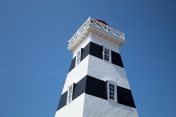 Blue and white lighthouse background image with blue sky in New Brunswick, Canada