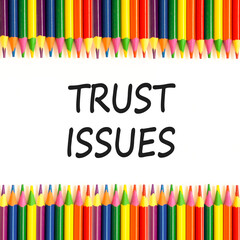 Trust issues symbol. Concept word Trust issues on beautiful white paper. Colored pencils. Beautiful white paper background. Business trust issues concept. Copy space.