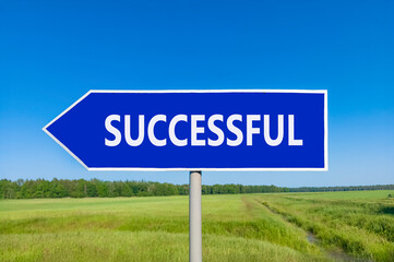 Successful symbol. Concept word Successful on beautiful blue road sign. Beautiful blue sky green grass and forest peaceful nature background. Business successful concept. Copy space.