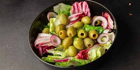 Salad olives, green leaf lettuce, vegetables natural product tasty snack fresh delicious gourmet food background on the table rustic top view copy space keto and paleo diet vegan and vegan food