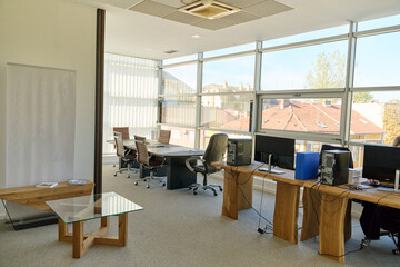 Modern Office Interior with Wooden Furniture, Conference Table, and Computers