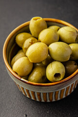 Green olives pickled seedless natural product tasty snack fresh delicious gourmet food background on the table rustic top view copy space