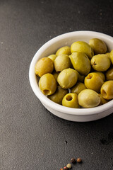 Green olives pickled seedless natural product tasty snack fresh delicious gourmet food background on the table rustic top view copy space