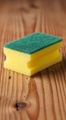 Yellow and Green Cleaning Sponge on Wood.
