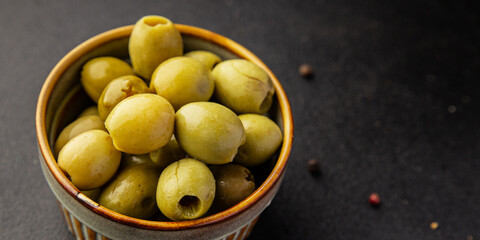 Green olives pickled seedless natural product tasty snack fresh delicious gourmet food background on the table rustic top view copy space