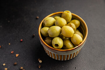 Green olives pickled seedless natural product tasty snack fresh delicious gourmet food background on the table rustic top view copy space