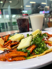 Mexican tacos al pastor with pineapple and horchata drink