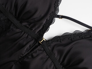 Women's black underwear on a white background close-up. Peignoir