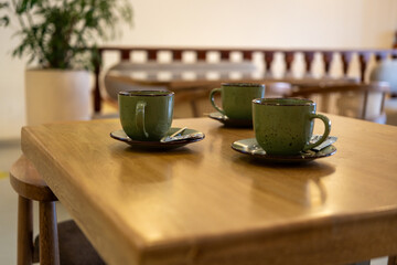 Close-up of three cups of coffee on a table in a cafe