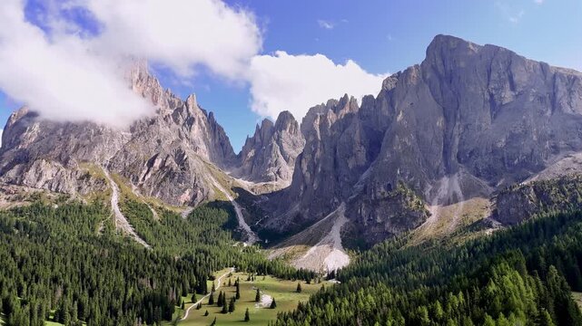 Aerial view of Langkofel mountain in Dolomites, Italy. The top of a mountain Plattkofel Sassopiatto. Dolomites mountain ridge. Seiser Alm Alpe di Siusi aerial view at Summer. Travel in Italy.