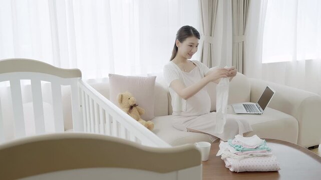 Pregnant woman preparing things for her upcoming baby