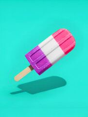 Three-flavored ice cream popsicles with a bright blue background and sunshade. Summer food concept.