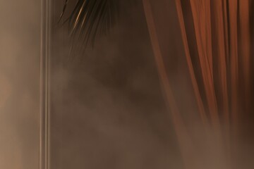 A curtain with a leafy green plant in the background. The curtain is brown and the background is blurry