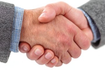 Close-up of a handshake between two people in business attire.