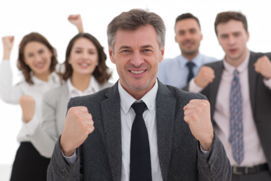 A group of diverse business professionals celebrating a successful achievement with raised fists and smiles.
