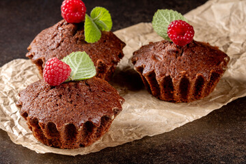 Mouth-watering muffins with raspberries on a chic black kitchen table surface