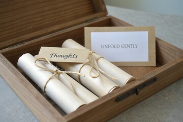 Rolled paper scrolls with messages stored in a wooden box
