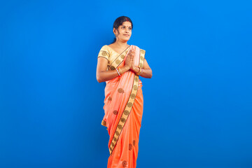 portrait of Indian woman in sari posing with traditional Namaste gestureDescriptions