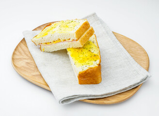 Classic Croque Monsieur Sandwich on Wooden Plate and Napkin Toasted Ham and Cheese with Egg Topping on white background side view