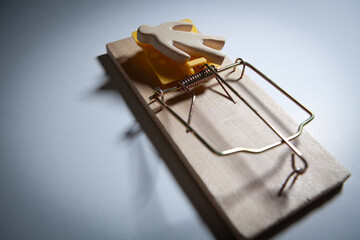 Mousetrap with a wooden euro sign on a white background
