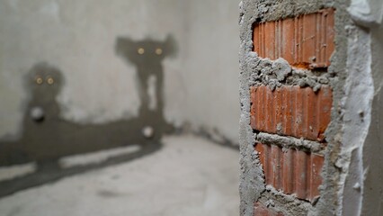 Creepy shadow monsters with glowing eyes on concrete wall