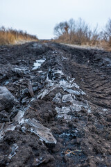 Detailed Close-up of Frozen Muddy Pathway with Ice Fragments