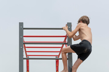 A little boy is engaged in gymnastics equipment