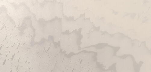 Subtle beige stucco wall texture with a soft, aged appearance, perfect for adding a touch of vintage charm to backgrounds and design projects