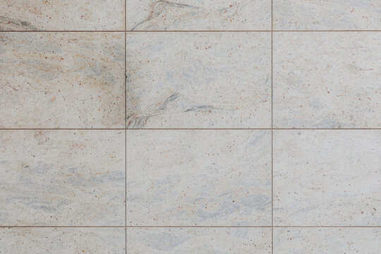 Light granite stone tiles with grout lines, top view
