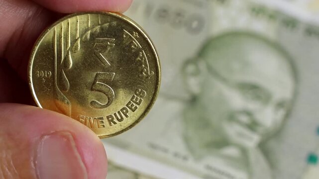Close up view of brand new five hundred indian rupees (INR) banknotes, coins. Concept of financial goals, success, literacy and income planning, saving money for retirement, cash settlement in India.