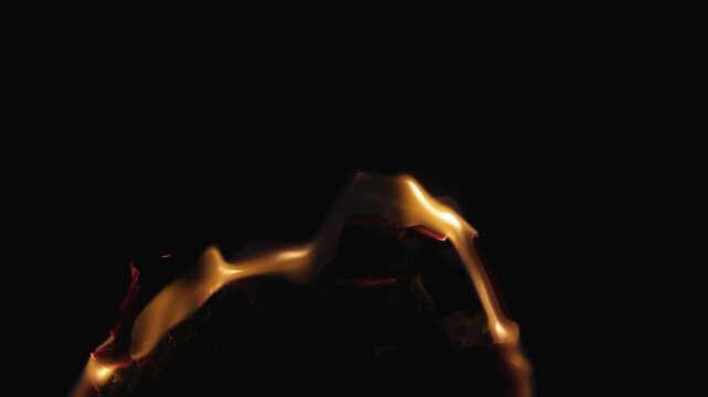 Burning paper, glowing edge of paper on a black background. Mockup for your logo. Wide angle horizontal wallpaper or web banner. flame effects for overlay designs or screen blending mode to make high.