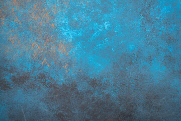 Abstract background with grunge blue, black, and orange textured surface