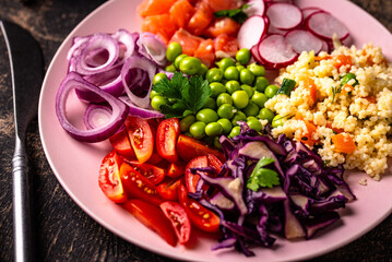 Balanced healthy bowl with vegetables and salmon