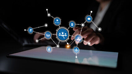 A modern business concept showcasing digital networking with colorful icons on a tablet. It...