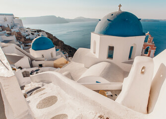 Oia Santorini Greece view overlooking caldera and sea, blue church domes