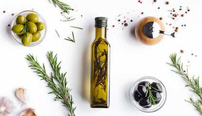 Fresh olives and oil in bottle with rosemary on white background with scattered spicies, top view