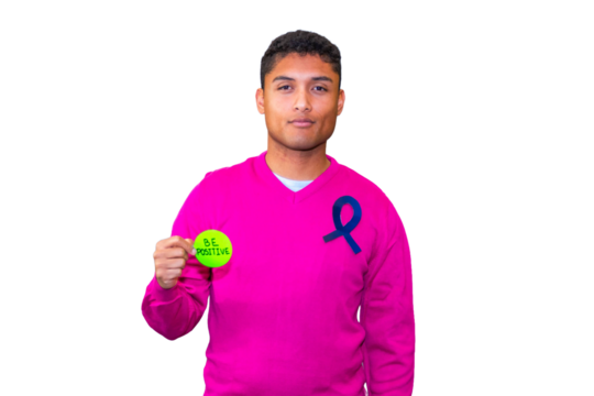 Young man showing a be positive message for cancer awareness.