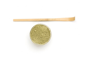 tea stick and bowl with dry matcha powder